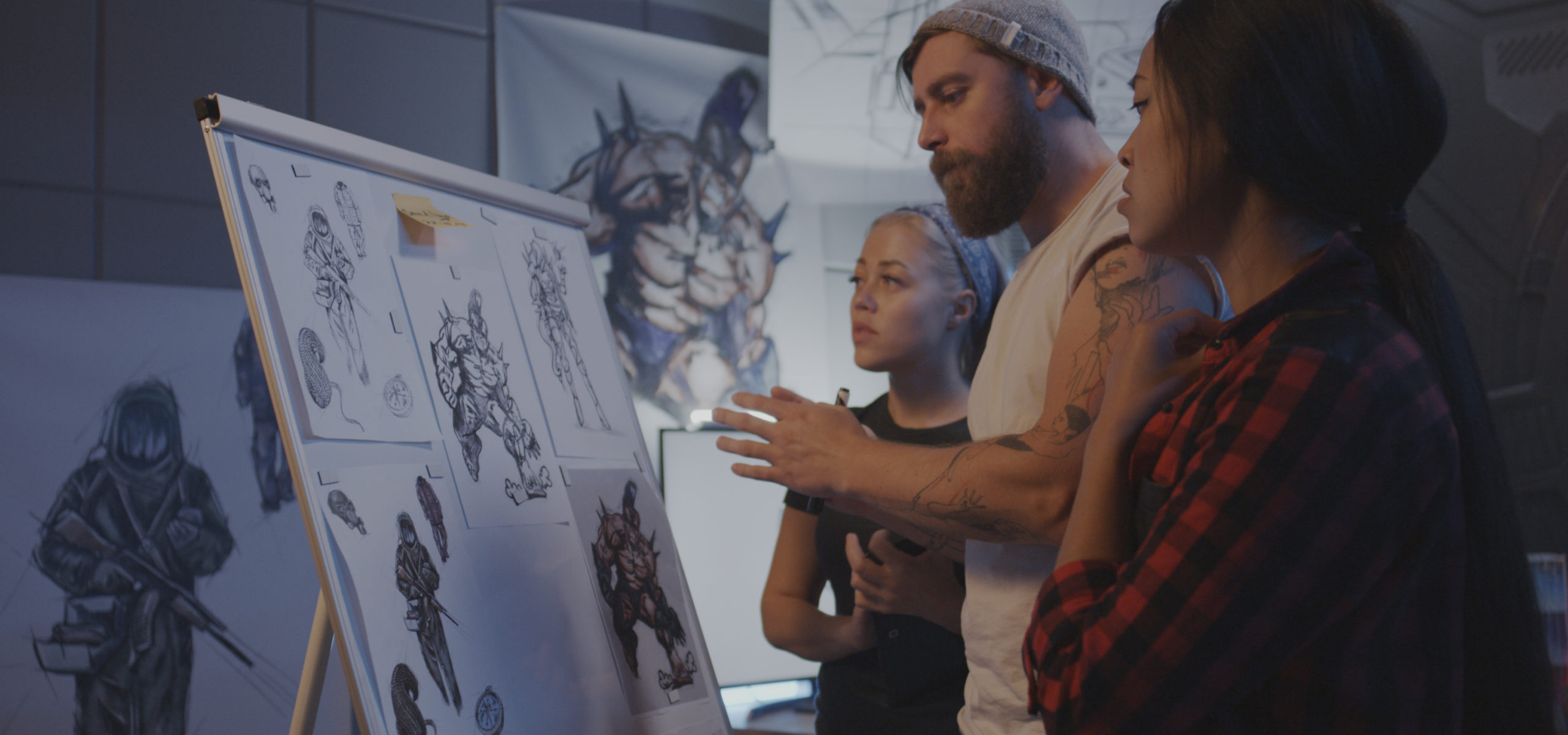 Medium shot of female designers discussing video game artwork