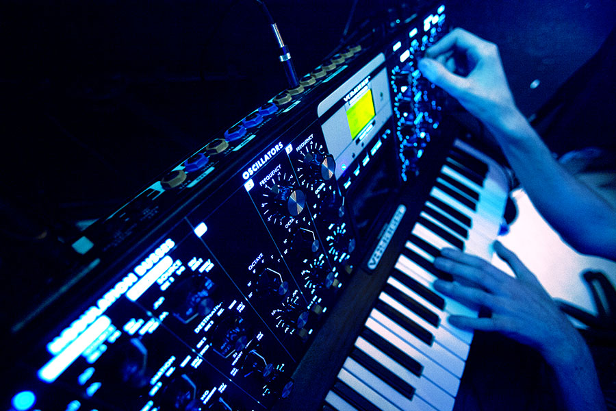 USV Electronic Music Production students working hands-on in the studio with an electric keyboard.