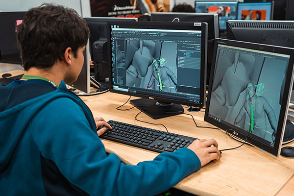 USV Digital Art & Animation student working in the classroom, animating a 3D-modeled character.