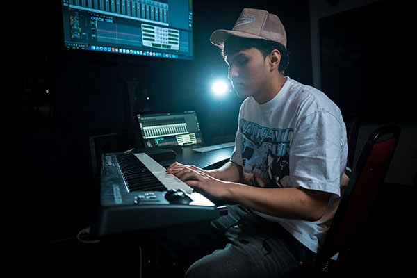 USV Audio & Music Technology student recording electronic music in the studio.